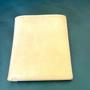 Genuine Leather Wallet. Brown and lays flat in your pocket. Can hold a lot.